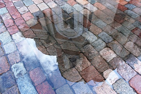 reflection of the cathedral in a puddle after rain  in the medieval town of Tallinn, Estoniaの写真素材