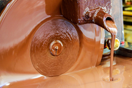 liquid chocolate in a chocolate artisan shopの写真素材