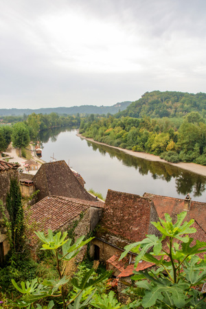 The picturesque village of La Roque Gageac reflecting in Dordogne riverの写真素材