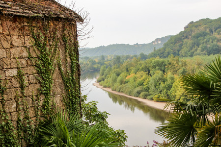 The picturesque village of La Roque Gageac reflecting in Dordogne riverの写真素材