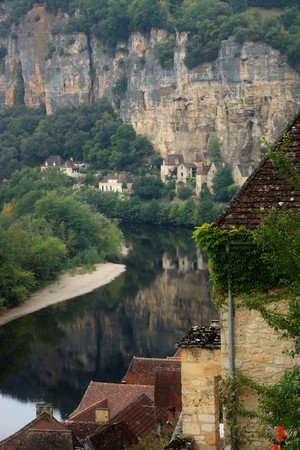 The medieval  village of La Roque Gageac reflecting in Dordogne riverの写真素材