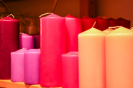 colored scented candles in different shades of pinkの写真素材
