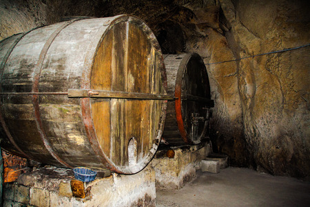 Wood wine barriques in a cellar of Tufo in Irpinia, Avellino, Campania, Italy