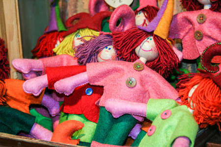 multicolored little dolls in wool fabricの写真素材