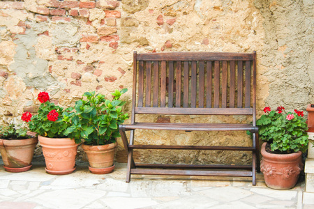 bench against an old wall in tuscanyの写真素材