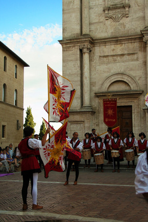 At Pienza - Italy - On 8/30/2012 - Flag wavers in the cathedral squareのeditorial素材