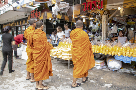 At Bangkok, Thailand - On September 2018 - Monks shopping in the traditional flower marketのeditorial素材