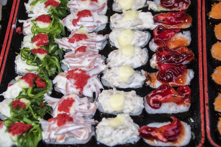 variety of sushi in a stall  as street food served in the night market of Kanchanaburi in Thailandのeditorial素材
