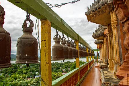 Bronze bells of the ancient temple at Kanchanaburi called Wat Tam Sua, Thailandの写真素材