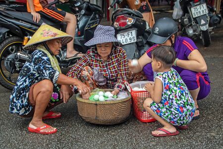 At Hue - Vietnam - On august 2019 - women and kids with a basket of eggs  at  Dong Ba Market,  the oldest market in Hue Cityのeditorial素材