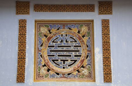 Decorated window in the Imperial City (Vietnamese: HoÃ ng thÃ nh), the  walled enclosure within the citadel (Kinh thÃ nh) of the city of Huáº¿, the former imperial capital of Vietnamの写真素材