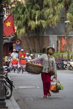 At Hue - Vietnam - On august 2019 - woman carrying goods on her  shoulderのeditorial素材