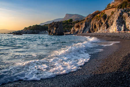 Scenic sunset on the beach of Santa Teresa at Maratea in Basilicata, Italy