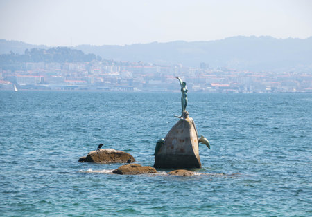Statue representing a mermaid in the sea of Cangas , Galicia, Spainの写真素材