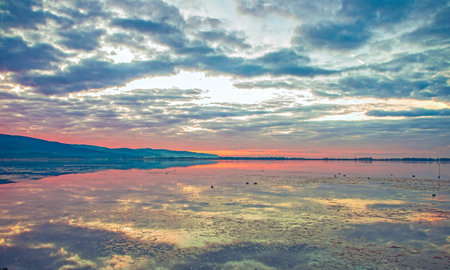 landscape of Orbetello Lagoon at sunset, the most important lagoon of the Tiyrrhenian sea and natural reserve in the Grosseto province, Tuscany, Italyの写真素材