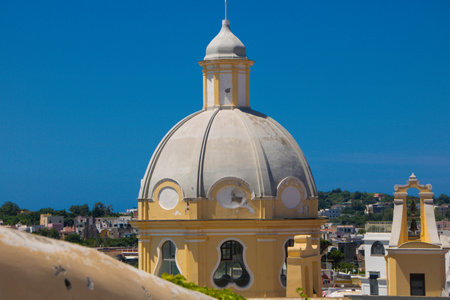 View of Marina Corricella and Madonna delle Grazie church in Procida, Naples