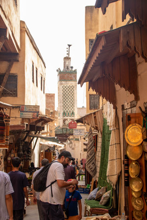 At Fes, Morocco, On 05, August, 2024, street in in the Medina with a minaret on the backgroundの写真素材