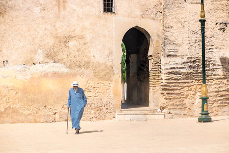 At Fes, Morocco on 08/07/24, man with a blue traditional djellaba in Place bou jeloud and the...
