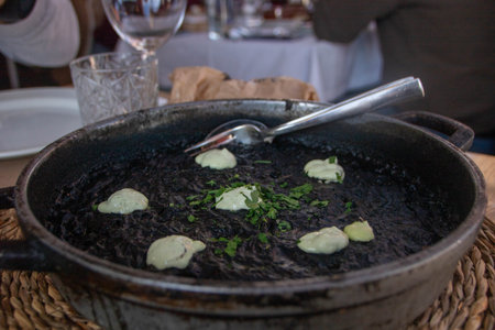 arroz negro or black paella made with squid ink, typical spanish recipeの写真素材
