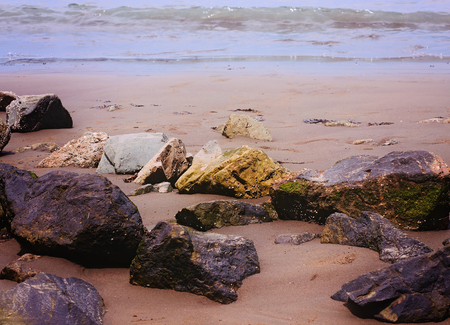 large group of beautiful sea rocks at sandy beachの写真素材