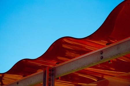 red roof on modern, built structure, on a clear dayの写真素材
