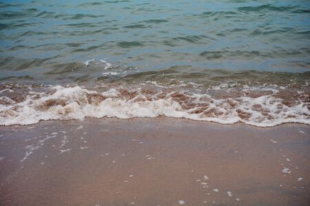 calm waves rolling in on a sandy beach, in San Francisco, Californiaの写真素材
