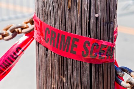 Crime Scene Tape on Wooden Post on a San Francisco City Streetの写真素材