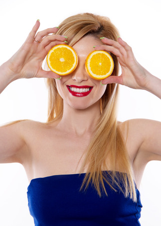 the blond woman with fresh juice fruit isolated on the white backgroundの写真素材