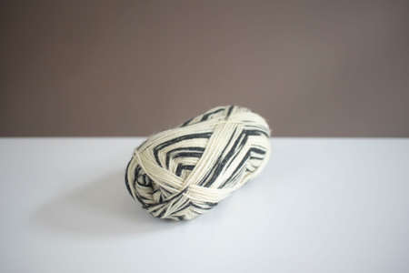 Black and white ball of yarn on white table in daylight. closeup, bright.の写真素材