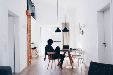 Relaxed woman working with notebook on a winter day.の写真素材