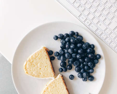 Lemon cake on plate with blueberries.の写真素材