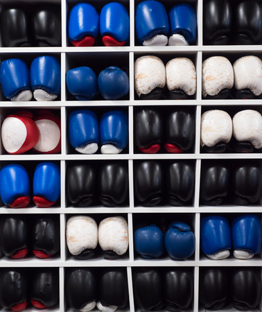 A picture of collection of boxing gloves on the shelve. Perfect for promotion of boxing and fitness.の写真素材