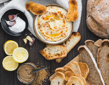 Healthy Homemade Creamy Hummus with the ingredients. Top view. Mediterranean dish made of chickpea beansの写真素材
