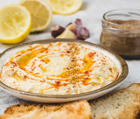 Healthy Homemade Creamy Hummus with the ingredients. Top view. Mediterranean dish made of chickpea beansの写真素材
