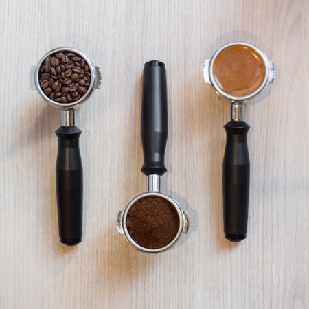 Coffee machine handles with coffee beans, coffee powder and espressoの写真素材