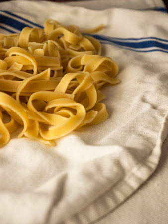 Fresh pasta resting on a kitchen towelの写真素材