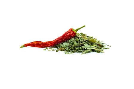 Red hot chili peppers and seasoning in form of a handful of green dried leaves, close-up isolated on a white background.の写真素材
