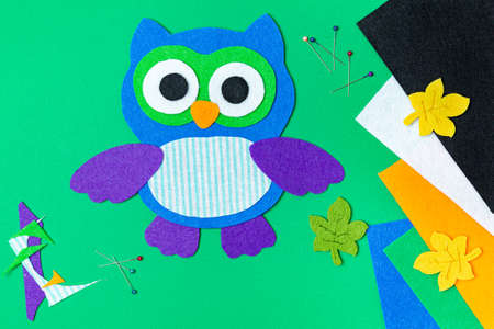 Craft, applique of an owl from multi-colored felt. Creative classes with children. Sewing soft toys,...