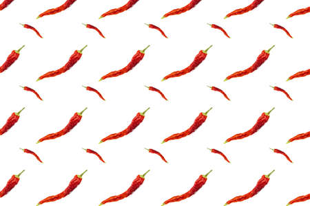 Seamless pattern of dried red chili peppers or cayenne chili peppers isolated on white background. Spicy hot seasoning. Ingredient for cooking spicy dishes. Traditional cuisine. Pattern for packaging.の写真素材