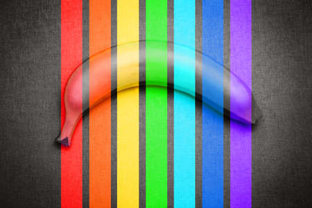 Banana in the colors of the rainbow on a black background. Vertical rainbow stripes. The colors of the lgbt flag. Abstract background. Copy space.の写真素材