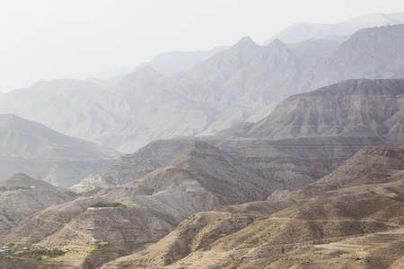 Misty mountain hills landscape. Layers of rocky mountains and hills in haze, sepia, gradient....