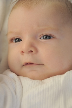 Cute baby boy having a curious lookの写真素材