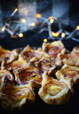 Nectarine roses from puff pastry, lights and star bokeh in the background