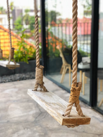 Wooden rustic tropical swing made with hemp rope