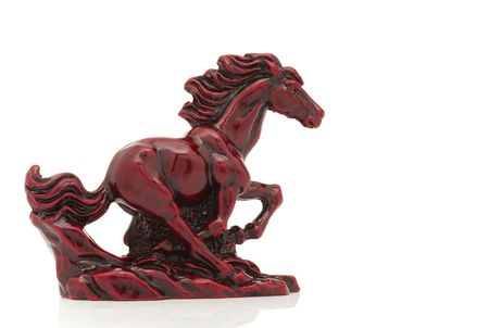 Old-fashioned figurine red horse isolated on white background.の写真素材