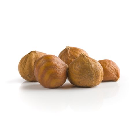 Pile of peeled hazelnuts over white backgroundの写真素材