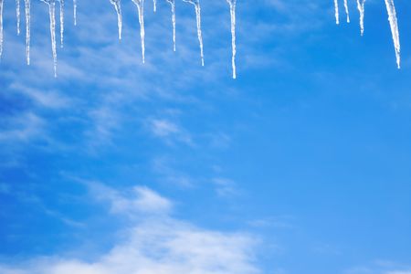 Icicles over blue pure sky. Skyscapeの写真素材