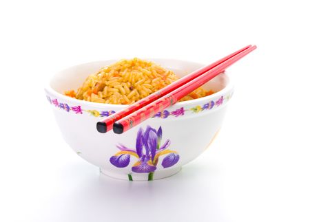 Bowl of cooked rice with chopsticks over white backgroundの写真素材