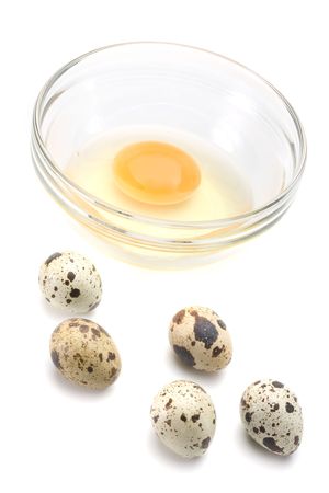 Dish of liquid egg and quail eggs over white backgroundの写真素材