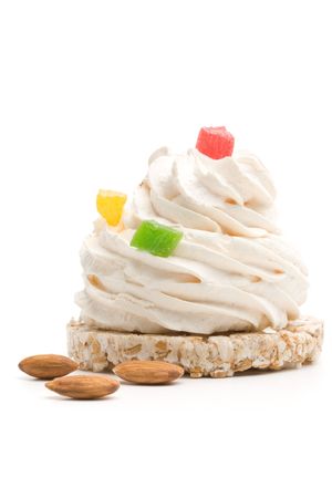 Meringue cake decorated with candied fruits isolated on a white backgroundの写真素材